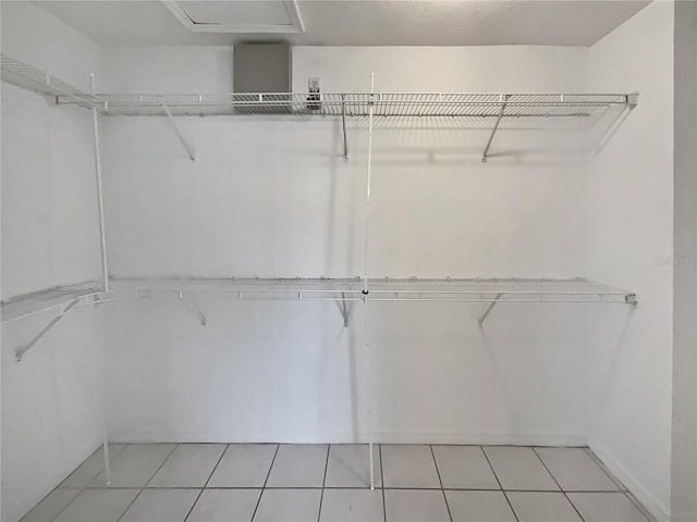 spacious closet featuring light tile patterned flooring