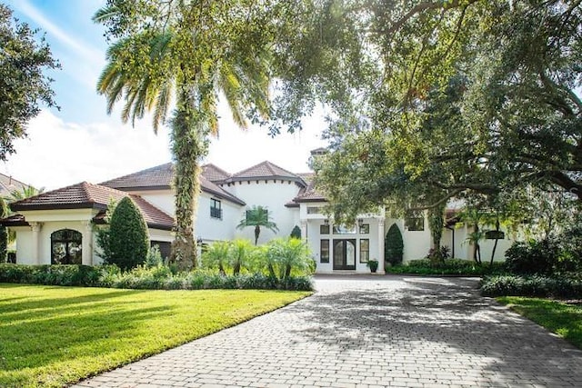 mediterranean / spanish-style house featuring a front lawn