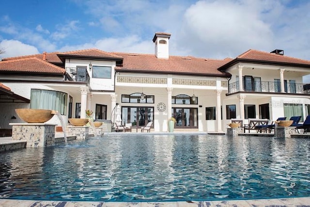 view of swimming pool featuring pool water feature and a patio area