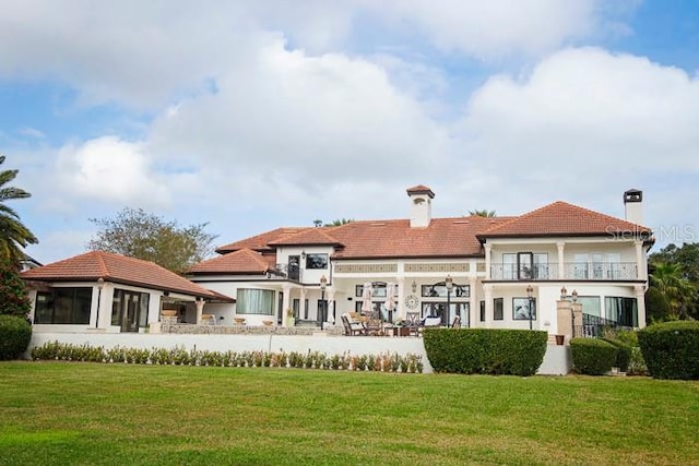 rear view of property featuring a yard