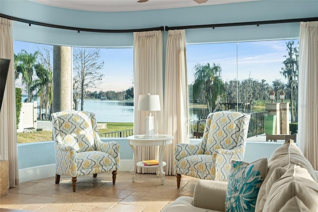 sunroom / solarium featuring a water view