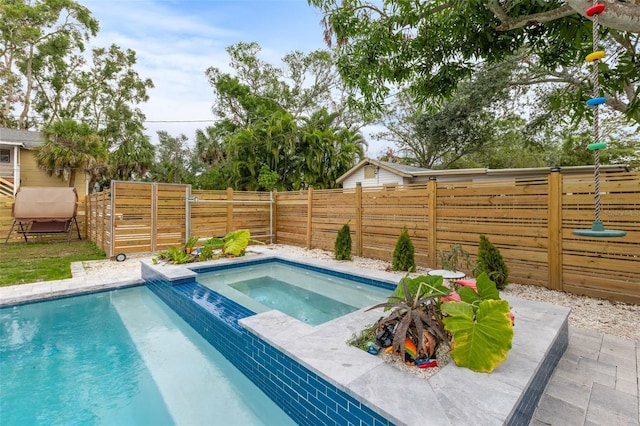 view of pool with a fenced backyard, a fenced in pool, and an in ground hot tub