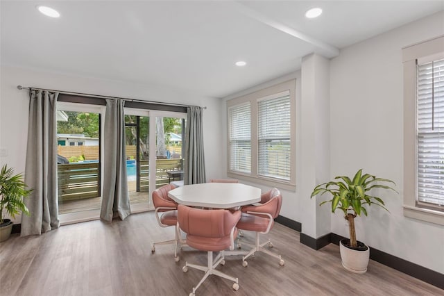 dining room with light wood-style floors, baseboards, and recessed lighting