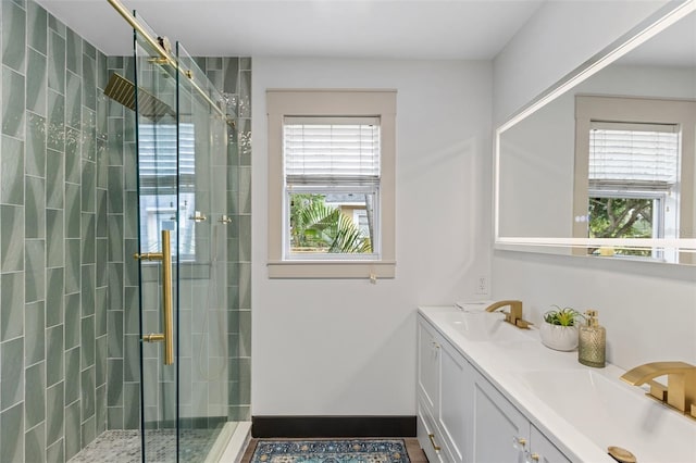 bathroom featuring a stall shower, plenty of natural light, and a sink