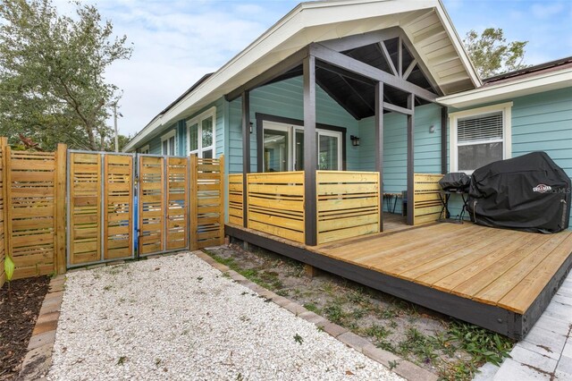 exterior space featuring a gate, fence, and a deck