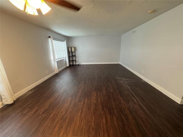 empty room with a textured ceiling, ceiling fan, and dark wood-type flooring