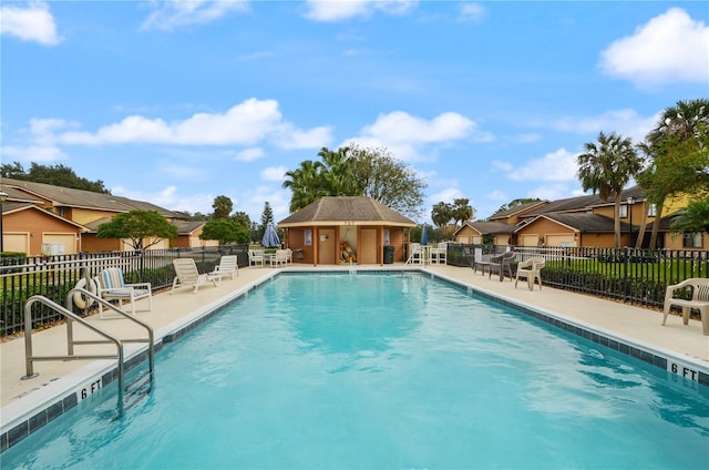 view of pool featuring a patio area and an outdoor structure