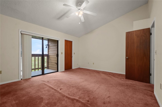 spare room with a textured ceiling, ceiling fan, carpet, and lofted ceiling