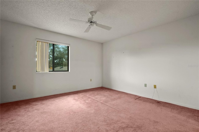 carpeted spare room featuring a textured ceiling and ceiling fan