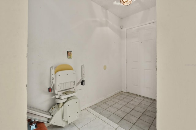 tiled foyer entrance featuring a textured ceiling