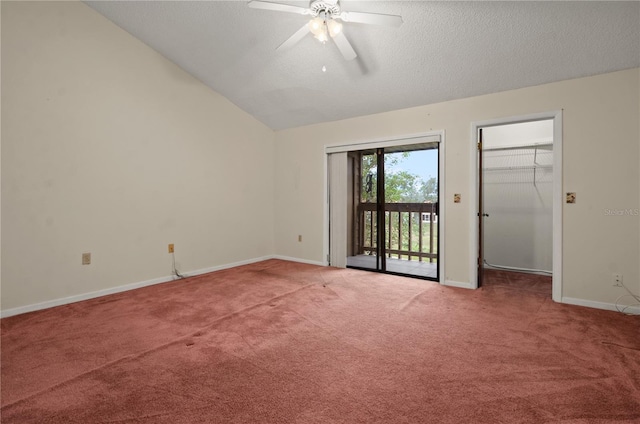 carpeted empty room with a textured ceiling, ceiling fan, and lofted ceiling