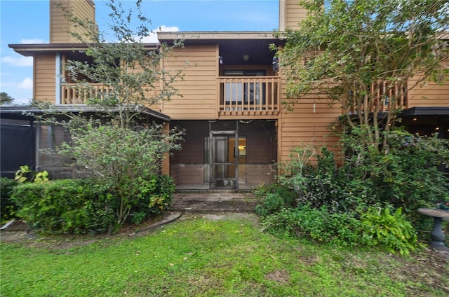 back of property featuring a balcony