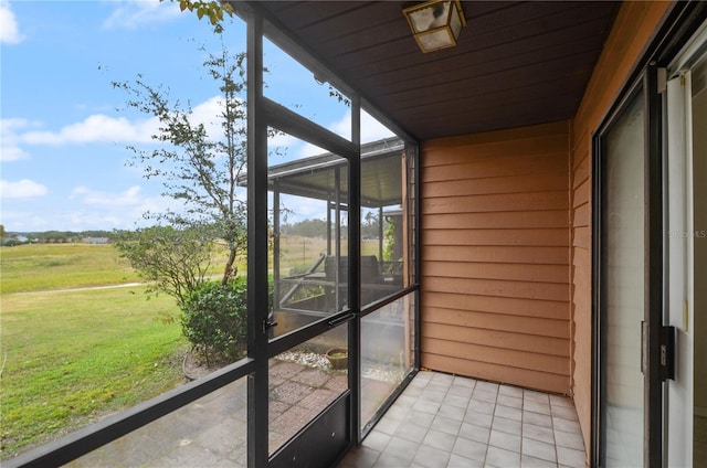 unfurnished sunroom with a rural view