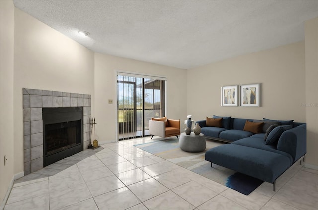 tiled living room featuring a tile fireplace and a textured ceiling