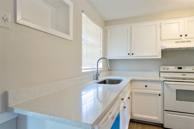 kitchen with white appliances, light stone counters, white cabinetry, and sink