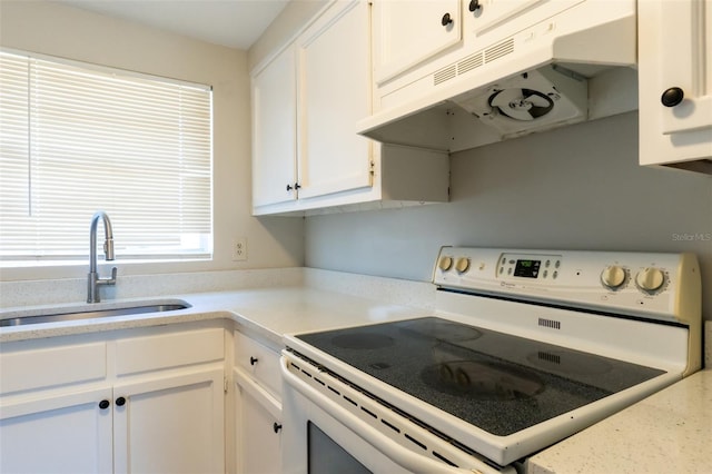 kitchen with sink, white cabinets, and white electric range