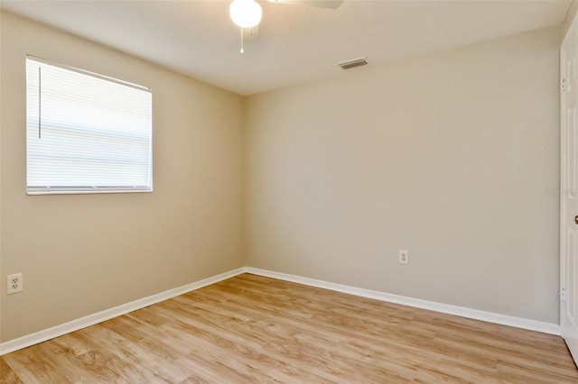 spare room featuring light wood-type flooring and ceiling fan