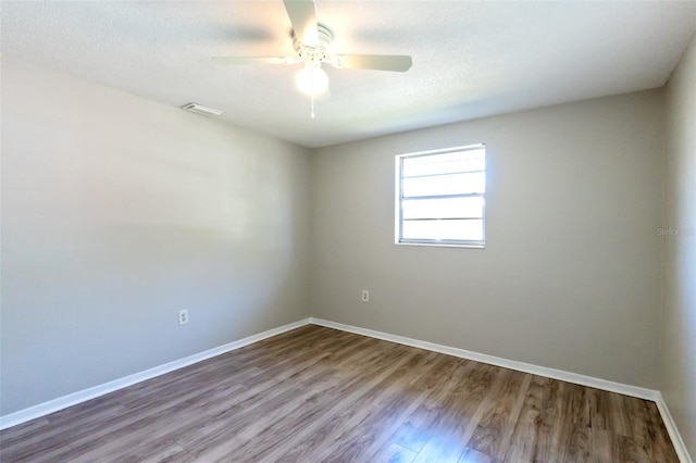 spare room featuring hardwood / wood-style floors, ceiling fan, and a textured ceiling