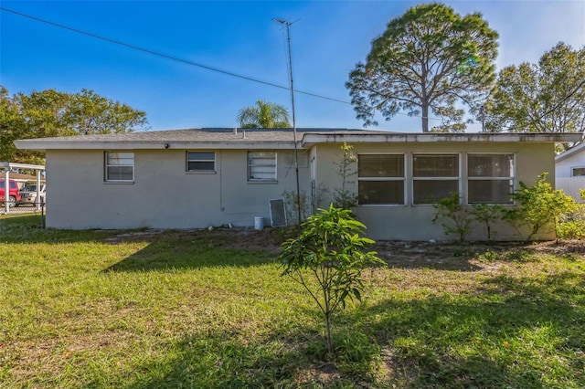 back of property featuring a yard