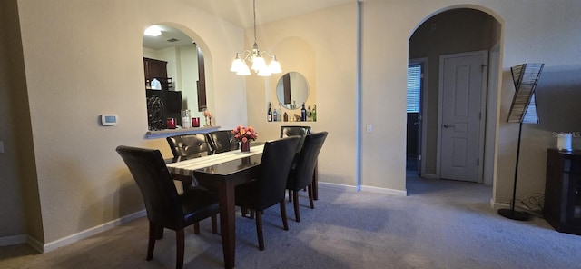 carpeted dining area with an inviting chandelier