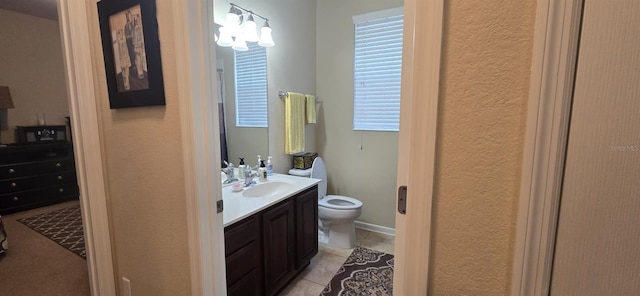 bathroom featuring tile patterned floors, vanity, and toilet