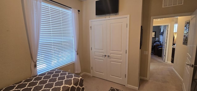 carpeted bedroom featuring a closet