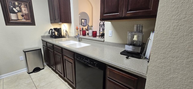 kitchen featuring dark brown cabinetry, dishwasher, sink, and light tile patterned floors