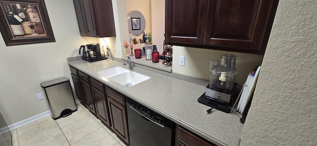 kitchen featuring dishwasher, sink, and light tile patterned floors