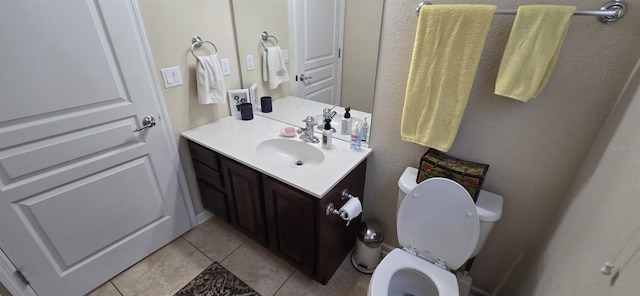 bathroom featuring tile patterned flooring, vanity, and toilet