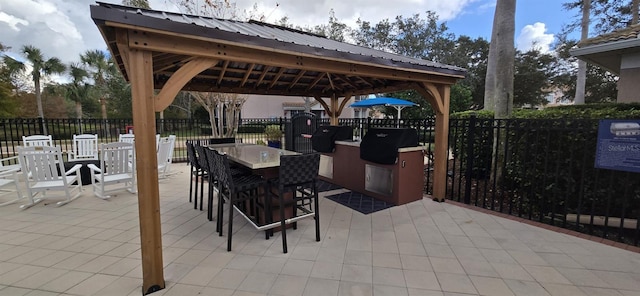 view of patio / terrace featuring a gazebo, an outdoor bar, and grilling area