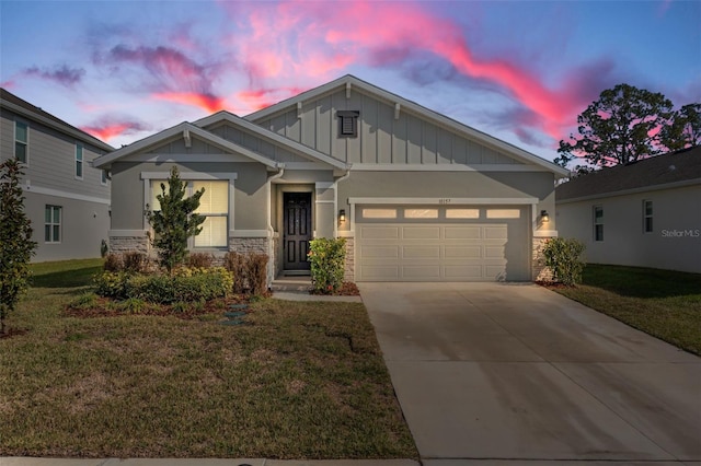 craftsman inspired home featuring a garage, stone siding, board and batten siding, and driveway