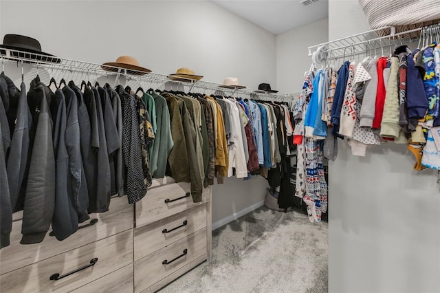 walk in closet featuring carpet flooring