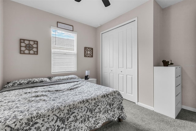 carpeted bedroom featuring ceiling fan and a closet