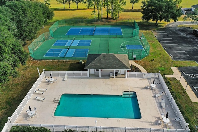 view of pool with a patio area and tennis court