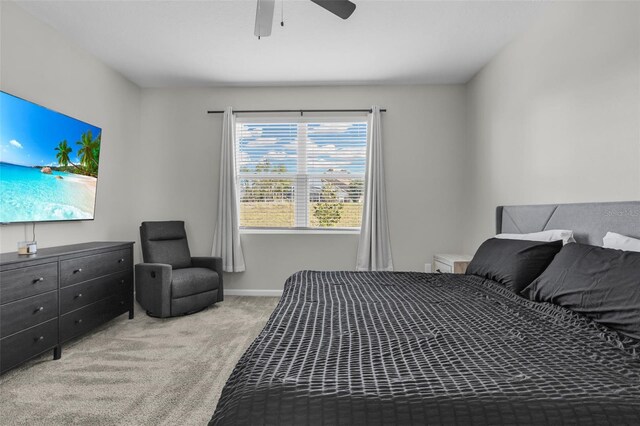 bedroom with baseboards, a ceiling fan, and light colored carpet