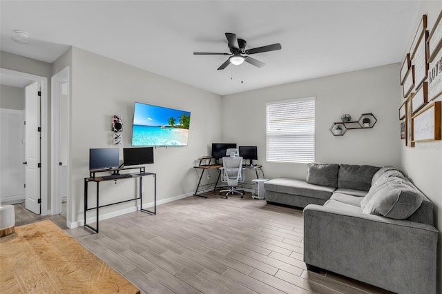 living room featuring wood finish floors, ceiling fan, and baseboards