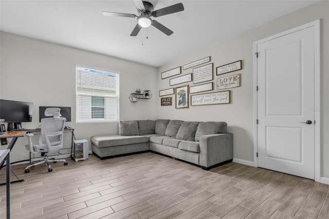 office area featuring a ceiling fan, wood finish floors, and baseboards