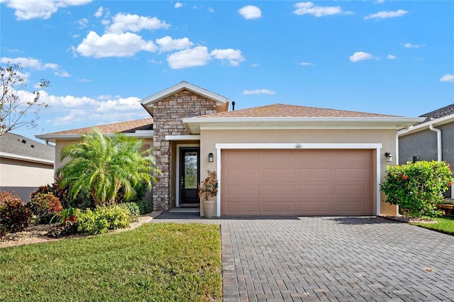 view of front of property with a front yard and a garage