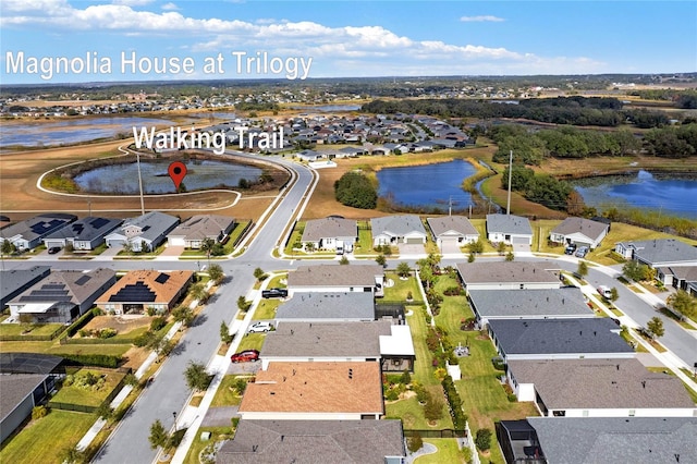 birds eye view of property with a water view and a residential view