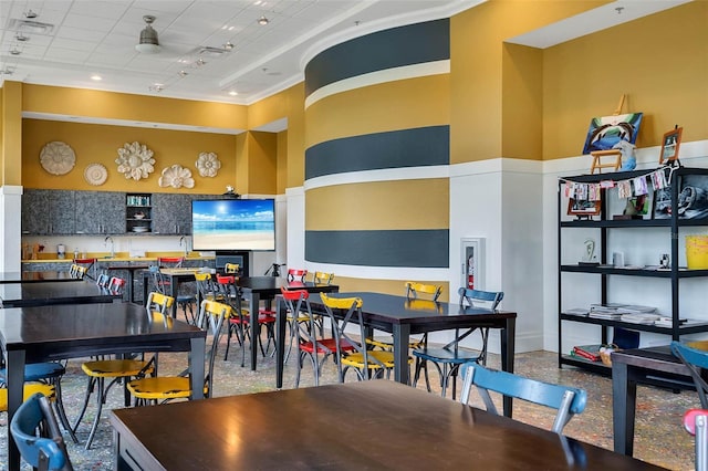 rec room featuring baseboards and ornamental molding