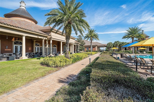 view of community with a yard, a patio, an outdoor hangout area, and a swimming pool