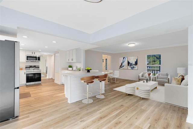 living room featuring light wood-type flooring and crown molding