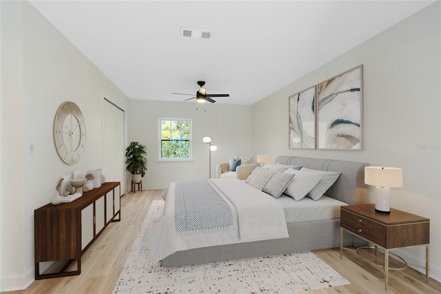 bedroom featuring a closet, visible vents, ceiling fan, and light wood finished floors