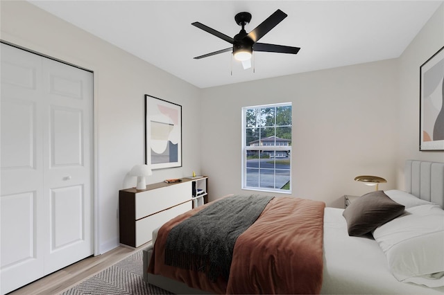 bedroom with light wood-type flooring, a closet, and ceiling fan