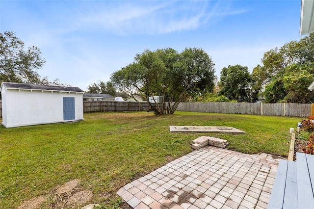 view of yard with a patio area and a storage shed