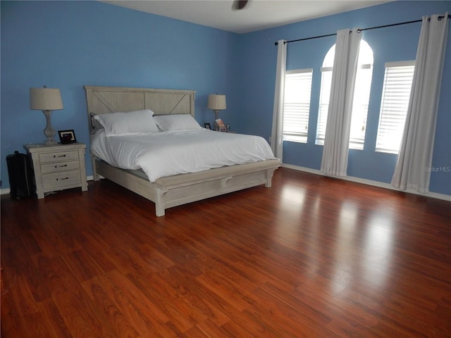 bedroom with dark hardwood / wood-style floors