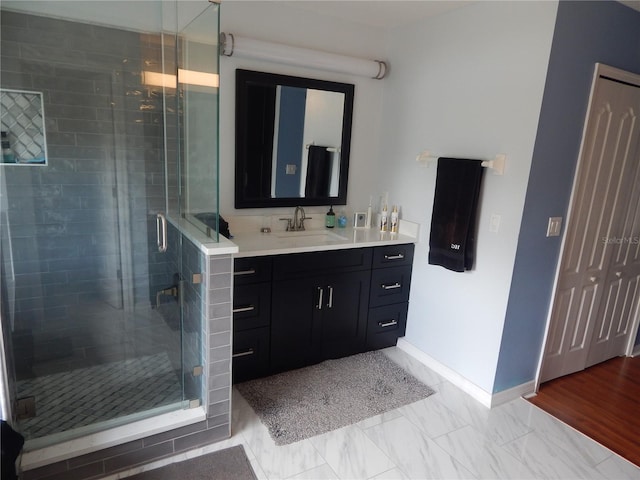 bathroom featuring vanity, wood-type flooring, and walk in shower