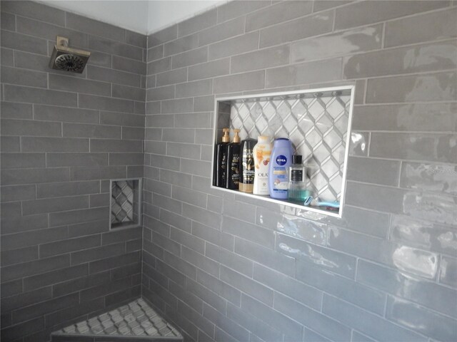 bathroom with tiled shower