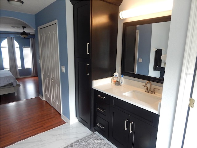 bathroom featuring hardwood / wood-style floors, vanity, and ceiling fan