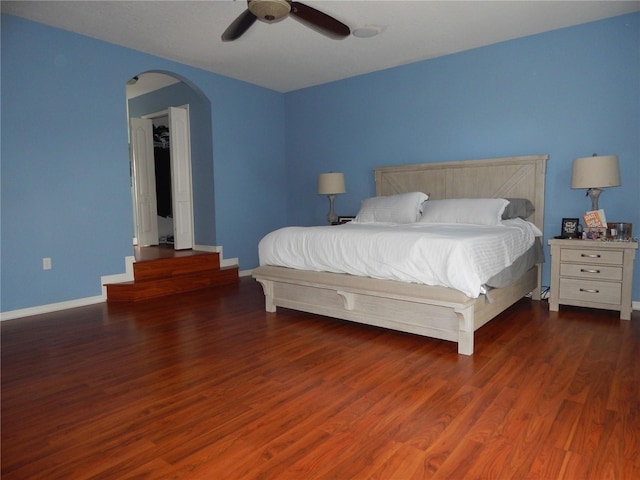 bedroom with dark hardwood / wood-style floors and ceiling fan